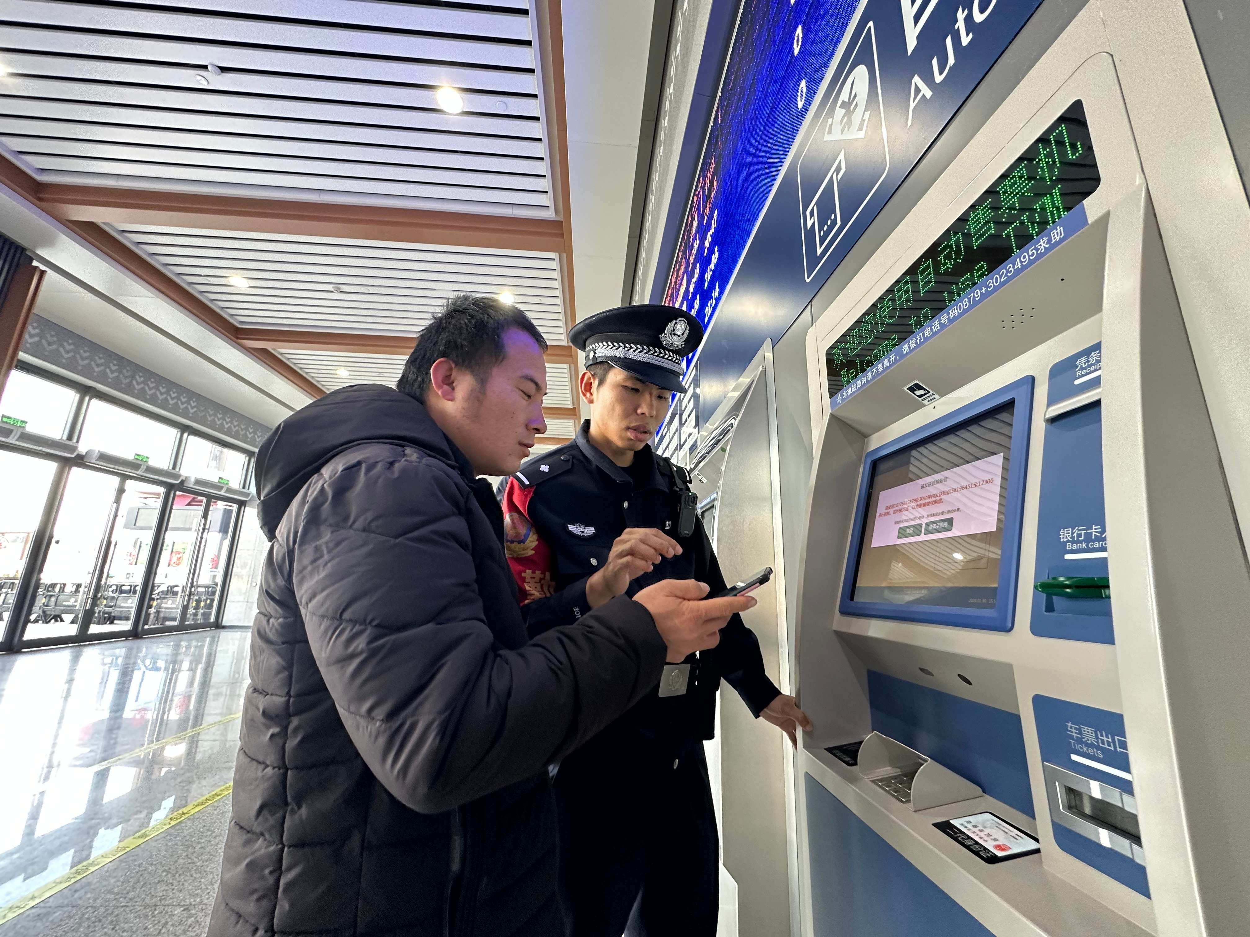 图6:李聪帮助旅客取票乘车.jpg